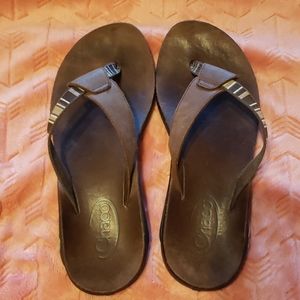 Brown leather Chaco sandals.